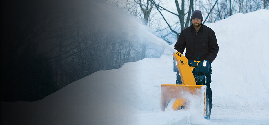 A man pushing a snow blower through heavy snow with the text, snow blower guide, learn how to pick the right one. Read more.